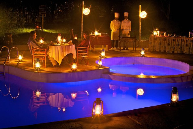 Romantic TENTED dinnerwith lanterns, staff serving gourmet safari cuisinE